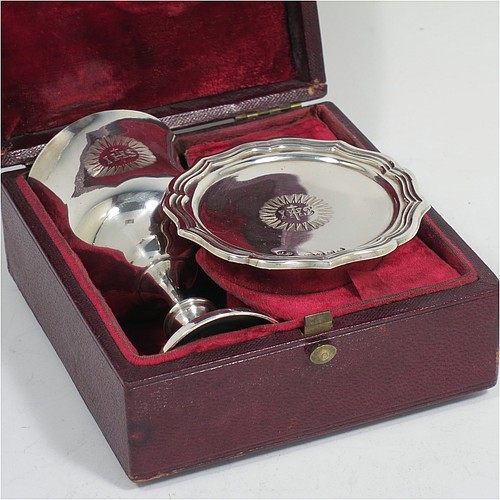 An Antique early Victorian Sterling Silver three-piece travelling communion set consisting of chalice, paten, and wine bottle. The chalice having a plain round bellied body, a gold-gilt interior, and sitting on a pedestal foot. The paten having a round body with an applied reeded and shaped border, and sitting on a collet foot. The wine bottle having a plain rectangular body with cut-corners and round screw-off lid, with a crystal stopper. All three pieces are hand-engraved with a Christogram, and they are all sitting in their original maroon velvet-lined presentation box. Made by John Evans II of London in 1844. The dimensions of this fine hand-made antique silver travelling communion set are height of chalice 9 cms (3.5 inches), diameter of paten 6.5 cms (2.5 inches), length of bottle 8cms (3.25 inches), and with a total weight of approx. 131g (4.2 troy ounces).    