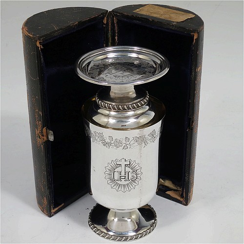 A very unusual and handsome Antique Victorian Silver Plated three-piece travelling communion set consisting of a chalice, paten, and wine bottle. The chalice having a round body with a gold-gilt interior, and sitting on a pedestal foot with a gadroon border. The paten having a round body sitting on a pedestal foot with a gadroon border. The wine bottle having a round body with a flat base and screw-off corked lid. All three pieces are hand-engraved with Christograms and a band of grapevine decoration, and sit in their original dark blue velvet-lined presentation box. All made in ca. 1848, with a contemporaneous inscription on the chalice. The dimensions of this fine hand-made antique silver-plated travelling communion set are height of chalice 10 cms (4 inches), diameter of paten 6.5 cms (2.5 inches), and height of bottle 9.5 cms (3.75 inches).