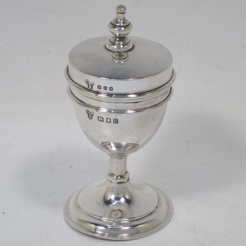 A handsome and unusual Antique Sterling Silver two-piece travelling communion set consisting of a chalice body for consecrated wine, together with lift-off pyx box with cover lid for host wafers. The lid with an applied urn-shaped finial, and the pyx body having a gold-gilt interior. Made by Charles Boyton and Sons of London in 1918. The dimensions of this fine hand-made antique silver travelling communion set are height 10 cms (4 inches), diameter of main body 4.5 cms (1.75 inches), and it weighs approx. 92g (3 troy ounces).  