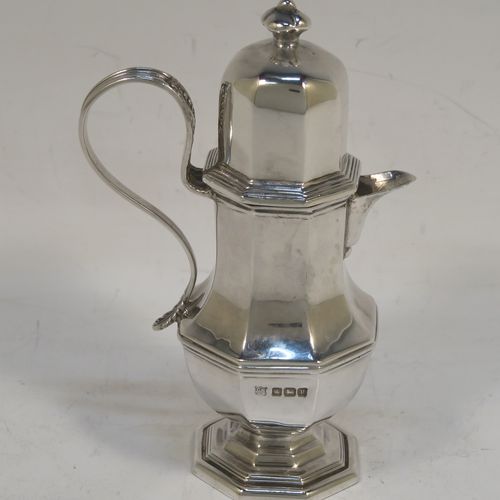 A very elegant and unusual Antique Sterling Silver  small travelling communion wine flagon or ewer, having a plain octagonal panelled body, with a reeded scroll handle, a sparrow-beak spout, a screw-in matching lid with cast finial, and all sitting on a pedestal foot. This handsome silver travelling communion wine ewer or flagon was made by Charles Boyton and Sons of Sheffield in 1913. The dimensions of this fine hand-made antique silver travelling communion wine ewer are height  11 cms (4.25 inches), length 7 cms (2.75 inches), and it weighs approx. 119g (3.8 troy ounces).   