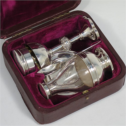 An Antique Victorian Sterling Silver five-piece travelling communion set consisting of a chalice, paten, wine ewer, pyx or wafer box, and anointing spoon, in original purple velvet and satin-lined presentation box. Made by Charles Boyton of London in 1884, the wafer or pyx box is by Frederick Wray in 1908, and the spoon by David Fullerton in 1928. The dimensions if this fine hand-made antique silver travelling communion set are height of chalice 10 cms (4 inches), diameter of paten 7.5 cms (3 inches), and the total weight of weighable silver is approx. 127g (4 troy ounces). Please note that the top of the presentation box has been embossed with an inscription.