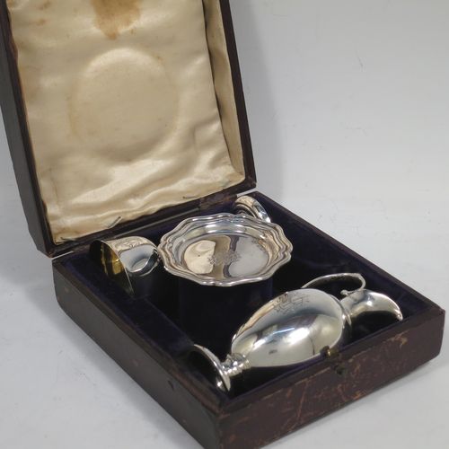 A handsome Antique Edwardian Sterling Silver three-piece travelling communion set consisting of chalice, paten, and wine flagon. In a plain round style, having a gold-gilt interior to the chalice,  an amphora style flagon, and a paten with an applied border and pedestal foot. All the pieces sit in their original cream satin and blue velvet-lined presentation box. Made by Thomas Wooley of Birmingham in 1902. The dimensions of this fine hand-made antique silver travelling communion set are height of flagon 9.5 cms (3.75 inches), diameter of paten 6 cms (2.5 inches), and with a total weight of approx. 113g (3.6 troy ounces). Please note that all items are engraved with a Christogram, and that the flagon does not have a stopper.   