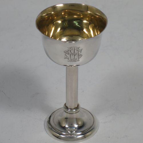 A handsome Antique Edwardian Sterling Silver three-piece travelling communion set consisting of chalice, paten, and wine flagon. In a plain round style, having a gold-gilt interior to the chalice,  an amphora style flagon, and a paten with an applied border and pedestal foot. All the pieces sit in their original cream satin and blue velvet-lined presentation box. Made by Thomas Wooley of Birmingham in 1902. The dimensions of this fine hand-made antique silver travelling communion set are height of flagon 9.5 cms (3.75 inches), diameter of paten 6 cms (2.5 inches), and with a total weight of approx. 113g (3.6 troy ounces). Please note that all items are engraved with a Christogram, and that the flagon does not have a stopper.   