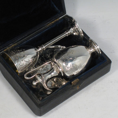 Antique Victorian sterling silver three-piece travelling communion set consisting of chalice, paten, and wine ewer (with lid and cork seal), all hand-engraved with floral work, in original velvet and satin-lined presentation box. Made by George Richards of London in 1856. Height of chalice 10 cms (4 inches), diameter of paten 7 cms (2.75 inches). Total weight approz. 154g (5 troy ounces).