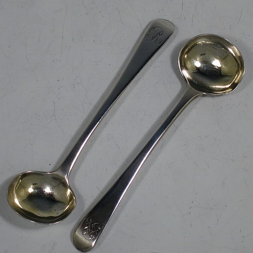 An Antique Georgian Sterling Silver pair of salt spoons, in the Old English pattern, with gold-gilt bowls. Made by Eley and Fern of London in 1814. The dimensions of these fine hand-made antique silver salt spoons are length 10 cms (4 inches), and they weigh a total of approx. 21g (0.7 troy ounces). Please note that these items are monogrammed.  