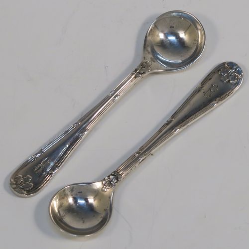 A very pretty pair of Sterling Silver salt spoons, in a double-struck Ribbon and Reed and Oak-Leaf pattern. These beautiful silver condiment spoons were made by Walker and Hall of Sheffield in 1933. The dimensions of these fine hand-made silver spoons are length 8.5 cms (3.3 inches), and they weigh a total of approx. 21g (0.7 troy ounces). Please note that they have a design registration number engraved on the back.   