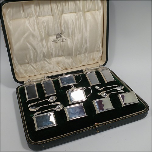 A Sterling Silver Art Deco ten piece condiment service, having octagonal straight-sided bodies, with original blue-glass liners, pull-off lids on the peppers, hinged lids on the mustards, and all in original green velvet and cream satin-lined presentation box. Consisting of two mustard pots, four pepper pots, four salt cellars, and six condiment spoons. Made by Edward and Sons of Birmingham in 1927. The dimensions of this fine hand-made sterling silver condiment service are height of peppers 7 cms (2.75 inches), length of mustard 6.5 cms (2.5 inches), and a total weight of approx. 323g (10.4 troy ounces). Please note that the silver condiment spoons are hallmarked new.