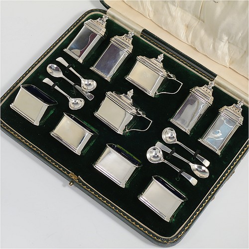 A Sterling Silver Art Deco ten piece condiment service, having octagonal straight-sided bodies, with original blue-glass liners, pull-off lids on the peppers, hinged lids on the mustards, and all in original green velvet and cream satin-lined presentation box. Consisting of two mustard pots, four pepper pots, four salt cellars, and six condiment spoons. Made by Edward and Sons of Birmingham in 1927. The dimensions of this fine hand-made sterling silver condiment service are height of peppers 7 cms (2.75 inches), length of mustard 6.5 cms (2.5 inches), and a total weight of approx. 323g (10.4 troy ounces). Please note that the silver condiment spoons are hallmarked new.