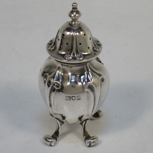 A handsome and large Antique Edwardian Sterling Silver seven-piece condiment service, consisting of a mustard pot with hinged lid and blue-glass liner, four salt cellars with blue-glass liners, and two pepper pots with pull-off lids, all with scroll fluted bellied bodies and sitting four scroll feet, and all fitted into their original dark blue satin and velvet-lined red presentation box. Made by James Round of London  in 1903. The dimensions of this fine hand-made condiment service are height of pepper pot 9 cms (3.5 inches), length of mustard pot 9 cms (3.5 inches), and with a total weight of approx. 353g (11.4 troy ounces).   