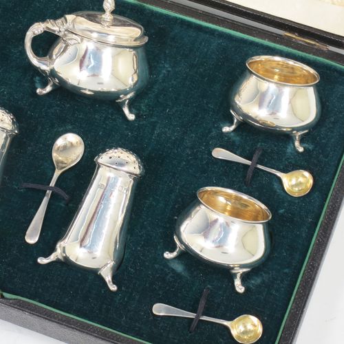 A pretty Antique Edwardian Sterling Silver seven-piece condiment service, having plain round bellied bodies, with gold-gilt linings for the salt cellars, pull-off lids on the peppers, a hinged lid on the mustard pot and original blue-glass liner, together with five condiment spoons, and all in their original dark green velvet and cream satin-lined presentation box. Consisting of one mustard pot, two pepper pots, four salt cellars, and five condiment spoons. All made by Charles Edwards of London in 1904 (apart from the mustard spoon which is hallmarked for 1934). The dimensions of this fine hand-made silver condiment set are height of peppers 6 cms (2.3 inches), length of mustard 6 cms (2.3 inches), and with a total weight of approx. 235g (7.6 troy ounces).    