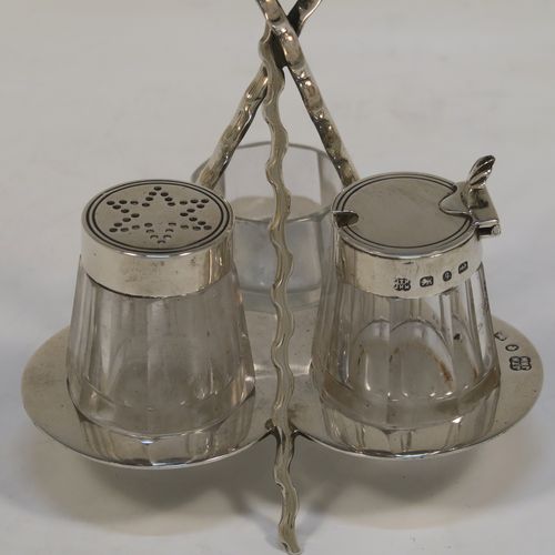 A very pretty and unusual Antique Victorian Sterling Silver Campfire style condiment set, consisting of a pepper shaker, mustard pot, and open salt with panelled cystal bodies and silver tops, all sitting in a campfire style frame with three tree branches joined together. This beautiful antique silver and crystal condiment set was made by Heath and Middleton of Birmingham in 1889. The dimensions of this fine hand-made antique silver condiment set are height 10 cms (4 inches), width 10 cms (4 inches), and it weighs approx. 70g (2.3 troy ounces).  