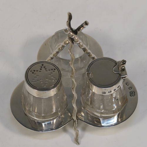 A very pretty and unusual Antique Victorian Sterling Silver Campfire style condiment set, consisting of a pepper shaker, mustard pot, and open salt with panelled cystal bodies and silver tops, all sitting in a campfire style frame with three tree branches joined together. This beautiful antique silver and crystal condiment set was made by Heath and Middleton of Birmingham in 1889. The dimensions of this fine hand-made antique silver condiment set are height 10 cms (4 inches), width 10 cms (4 inches), and it weighs approx. 70g (2.3 troy ounces).  