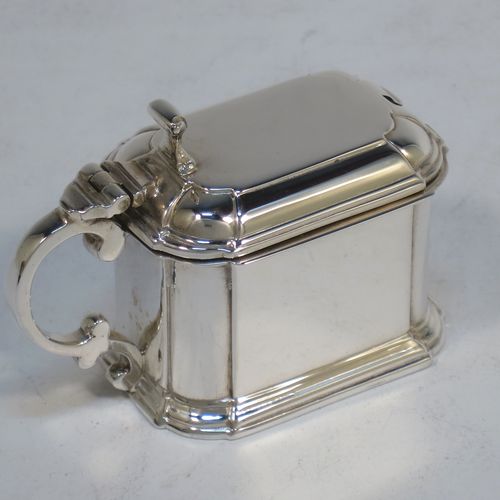 A very elegant Sterling Silver three-piece condiment set in an Art Deco style with straight-sided panelled bodies, consisting of an open salt cellar with a blue glass liner, a pepper pot with pull-off lid, a mustard pot with blue glass liner and hinged lid, together with two condiment spoons, and all in their cream satin and black velvet-lined presentation box. All made by Selfridges and Co., of Birmingham in 1939, apart from the spoons which are hallmarked for Birmingham in 1972. The dimensions of this fine hand-made silver condiment service are length of mustard pot 7 cms (2.75 inches), height of pepper pot 7.5 cms (3 inches), length of salt cellar 5 cms (3 inches), and with a total weight of approx. 118g (3.8 troy ounces).   