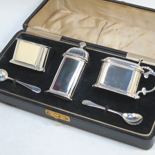 A very elegant Sterling Silver three-piece condiment set in an Art Deco style with straight-sided panelled bodies, consisting of an open salt cellar with a blue glass liner, a pepper pot with pull-off lid, a mustard pot with blue glass liner and hinged lid, together with two condiment spoons, and all in their cream satin and black velvet-lined presentation box. All made by Selfridges and Co., of Birmingham in 1939, apart from the spoons which are hallmarked for Birmingham in 1972. The dimensions of this fine hand-made silver condiment service are length of mustard pot 7 cms (2.75 inches), height of pepper pot 7.5 cms (3 inches), length of salt cellar 5 cms (3 inches), and with a total weight of approx. 118g (3.8 troy ounces).   