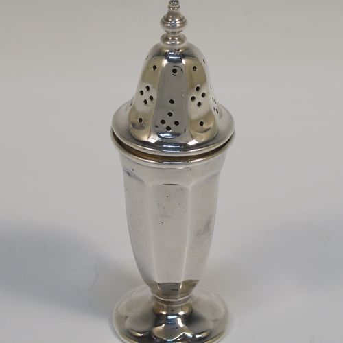 A handsome pair of Sterling Silver salt and pepper shakers, in a panelled Art Deco style, with pull-off lids and sitting on pedestal feet. These elegant silver salt and pepper pots were made by Emile Viner of Sheffield in 1938. The dimensions of this fine hand-made pair of silver pepper and salt shaker pots are height 10 cms (4 inches), diameter of main bodies 3.5 cms (1.3 inches), and the total weight is approx. 94g (3 troy ounces).  