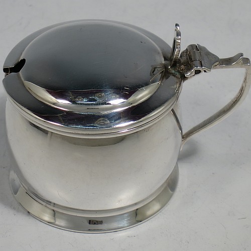 A Sterling Silver three-piece condiment set, in a very plain round bellied style, and consisting of two condiment spoons, a pepper pot, open salt cellar, and covered mustard pot, the latter two items with original blue glass liners, and all in their original cream satin and black velvet-lined presentation box. Made by Israel Sigmund Greenberg of Birmingham in 1939. The dimensions of this fine hand-made silver condiment service are height of pepper pot 7 cms (2.75 inches), length of mustard pot 7 cms (2.75 inches), and the total weight is approx. 88g (2.8 troy ounces).    