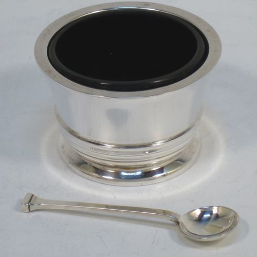 A very elegant Sterling Silver three-piece condiment set in an Art Deco style, consisting of an open salt cellar with a blue glass liner, a pepper pot with pull-off lid, a mustard pot with blue glass liner and hinged lid, together with two original condiment spoons, and all in their cream satin and maroon velvet-lined presentation box. Made by Deakin and Francis of Birmingham in 1970. The dimensions of this fine hand-made silver condiment service are length of mustard pot 7.5 cms (3 inches), height of pepper pot 7 cms (2.75 inches), diameter of salt cellar 6 cms (2.3 inches), and with a total weight of approx. 164g (5.3 troy ounces). 