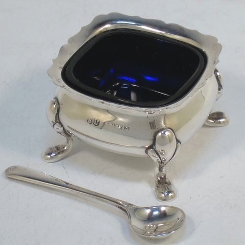 A pretty Sterling Silver three-piece condiment set in a traditional style with Chippendale borders, consisting of an open salt cellar with a blue glass liner, a pepper pot with pull-off lid, a mustard pot with blue glass liner and hinged lid, together with two original condiment spoons, and all in their cream satin and black velvet-lined presentation box. Made by William Suckling of Birmingham in 1955. The dimensions of this fine hand-made silver condiment service are length of mustard pot 7.5 cms (3 inches), height of pepper pot 8 cms (3 inches), width of salt cellar 5 cms (2 inches), and with a total weight of approx. 136g (4.4 troy ounces).  