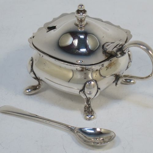 A pretty Sterling Silver three-piece condiment set in a traditional style with Chippendale borders, consisting of an open salt cellar with a blue glass liner, a pepper pot with pull-off lid, a mustard pot with blue glass liner and hinged lid, together with two original condiment spoons, and all in their cream satin and black velvet-lined presentation box. Made by William Suckling of Birmingham in 1955. The dimensions of this fine hand-made silver condiment service are length of mustard pot 7.5 cms (3 inches), height of pepper pot 8 cms (3 inches), width of salt cellar 5 cms (2 inches), and with a total weight of approx. 136g (4.4 troy ounces).  