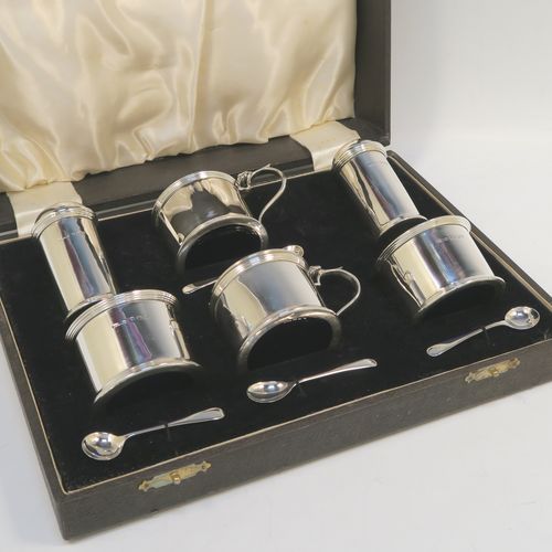 A very handsome Sterling Silver six-piece condiment set, in a very plain round Georgian style with applied reeded borders, and consisting of two pepper pots, two open salt cellars with blue-glass liners, and two covered mustard pots with hinged lids and blue-glass liners, together with two salt spoons and two mustard spoons, and all in their original cream satin and black velvet-lined presentation box. This beautiful silver condiment service was made by S. Blankensee and Sons of Chester and Birmingham in 1939. The dimensions of this fine hand-made silver condiment set are height of pepper pot 7 cms (2.75 inches), length of mustard pot 8 cms (3 inches), and the total weight is approx. 268g (8.6 troy ounces).  