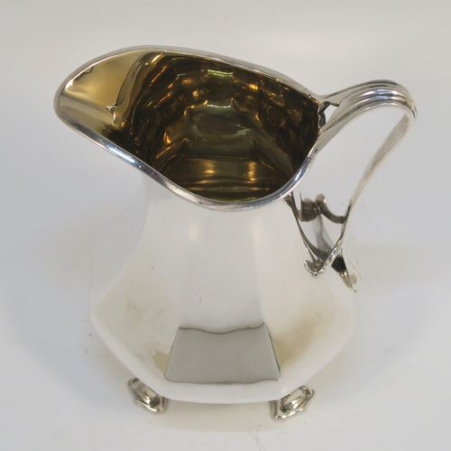 An elegant Antique Sterling Silver cream jug, in an Art Nouveau style having a plain panelled and bellied body, a scroll side-handle, a sparrow-beak spout, a gold-gilt interior, and sitting on four cast and pierced feet. This beautiful silver cream jug was made by Charles Clement Pilling of Sheffield in 1922. The dimensions of this fine hand-made antique silver cream jug are height 12.5 cms (5 inches), length 10 cms (4 inches), and it weighs approx. 210g (6.8 troy ounces).   