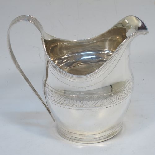 A very elegant Antique Georgian Sterling Silver cream jug, having a round bellied body with hand-chased bands of stipple and floral work, an applied reeded border and reeded scroll handle, and all sitting on a flat base. Made George Burrows of London in 1800. The dimensions of this fine hand-made antique silver cream jug are height 11 cms (4.25 inches), length 11.5 cms (4.5 inches), and it weighs approx. 101g (3.3 troy ounces).   