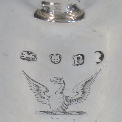 A very elegant Antique Georgian Sterling Silver cream jug, having a round body with tapering sides in a Helmet style, an applied bead-edged border, a reeded scroll handle, and sitting on a pedestal foot with a square base. Made in London in 1790. The dimensions of this fine hand-made antique silver cream jug are length 12 cms (4.75 inches), height 13 cms (5 inches), and it weighs approx. 117g (3.8 troy ounces). Please note that this item is crested.   