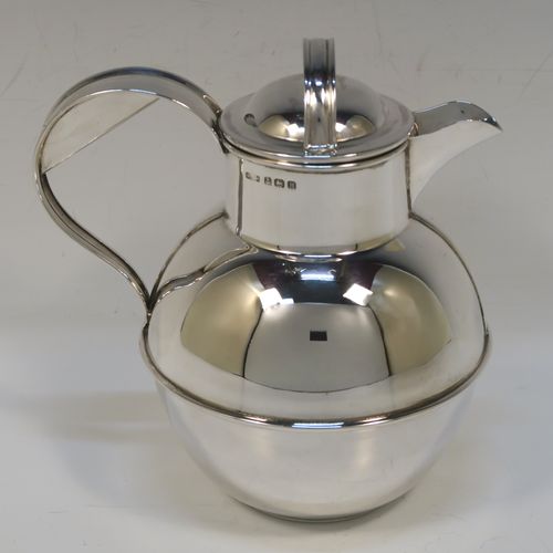 A large and unusual Sterling Silver Guernsey cream or milk jug, having a round bellied body, with a pull-off lid, a sparrow-beak spout, a scroll side-handle, and sitting on a flat base. This handsome silver Guernsey milk jug was made by William Holmes of Birmingham in 1936. The dimensions of this fine hand-made silver milk or cream jug are height 16.5 cms (6.5 inches), length 15.5 cms (6 inches), and it weighs approx. 296g (9.5 troy ounces). Please note that this silver Guernsey milk jug will hold 0.85 litres (1.5 pints).  