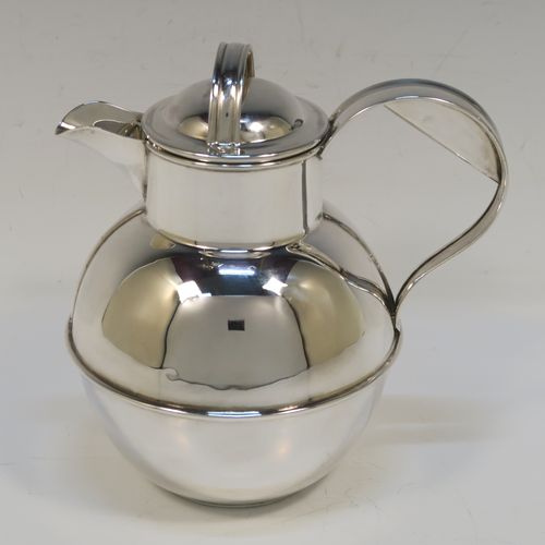 A large and unusual Sterling Silver Guernsey cream or milk jug, having a round bellied body, with a pull-off lid, a sparrow-beak spout, a scroll side-handle, and sitting on a flat base. This handsome silver Guernsey milk jug was made by William Holmes of Birmingham in 1936. The dimensions of this fine hand-made silver milk or cream jug are height 16.5 cms (6.5 inches), length 15.5 cms (6 inches), and it weighs approx. 296g (9.5 troy ounces). Please note that this silver Guernsey milk jug will hold 0.85 litres (1.5 pints).  