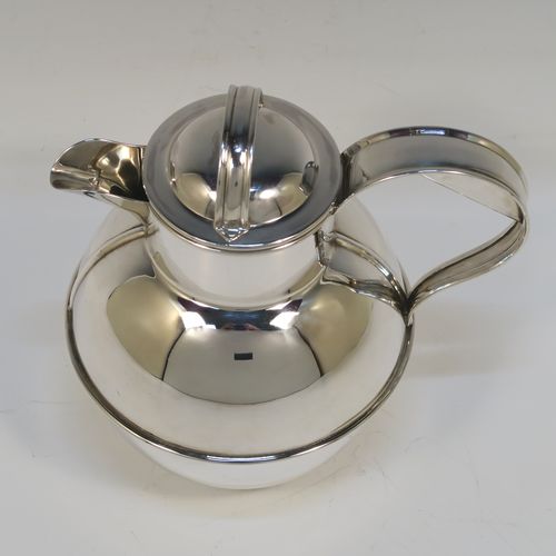 A large and unusual Sterling Silver Guernsey cream or milk jug, having a round bellied body, with a pull-off lid, a sparrow-beak spout, a scroll side-handle, and sitting on a flat base. This handsome silver Guernsey milk jug was made by William Holmes of Birmingham in 1936. The dimensions of this fine hand-made silver milk or cream jug are height 16.5 cms (6.5 inches), length 15.5 cms (6 inches), and it weighs approx. 296g (9.5 troy ounces). Please note that this silver Guernsey milk jug will hold 0.85 litres (1.5 pints).  