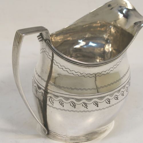 A very pretty Antique Georgian Sterling Silver cream jug, having a round bellied body with hand-engraved bands of stipple and floral work, an applied reeded border and reeded scroll handle, and all sitting on a flat base. This elegant antique silver cream jug was made by Urquart and Hart of London in 1786. The dimensions of this fine hand-made antique silver cream jug are height  cms (3.75 inches), length 11 cms (4.3 inches), and it weighs approx. 78g (2.5 troy ounces).   