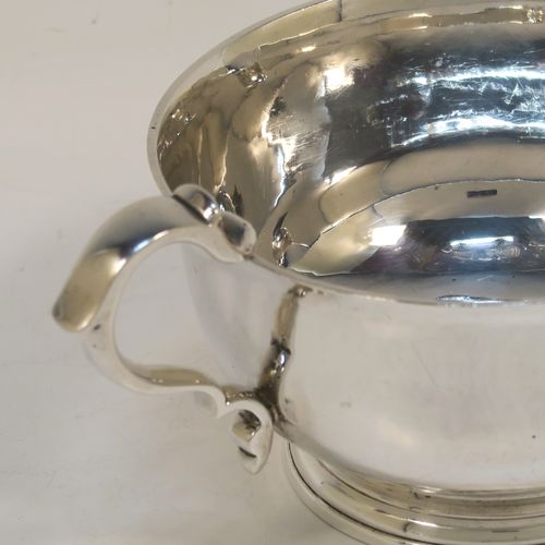 A heavy and very stylish pair of Sterling Silver sauce boats, having plain round bellied bodies, with sparrow beak spouts, cast scroll side-handles, and sitting on round collet feet. This handsome pair of sterling silver sauce boats were made by Tessier Ltd., of London in 1960. The dimensions of this fine pair of hand-made sauce boats are length 16 cms (6.25 inches), height 6.5 cms (2.75 inches), diameter 10 cms (4 inches), and they weigh a total of approx. 480g (15.5 troy ounces).   