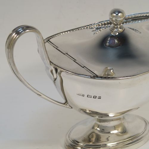 A handsome and rare Antique Edwardian Sterling Silver covered sauce boat, having a plain oval bellied body, with an applied rope-twist top border, a reeded scroll side handle, a hinged domed lid with a ball finial, and all sitting on an oval pedestal foot. This elegant antique silver covered sauce boat was made by Alstons and Hallam  of London in 1904. The dimensions of this fine hand-made antique silver covered sauce boat are length 19 cms (7.5 inches), width 10 cms (4 inches), height 12 cms (4.75 inches), and it weighs 463g (14.9 troy ounces).   