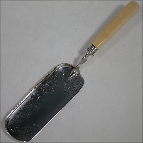 A very pretty Antique Victorian Sterling Silver crumb scoop, having a hand-engraved blade with floral and scroll decoration, and a plain bone handle with reeded ferrule. Made by Martin Hall and Co., of Sheffield in 1897. The dimensions of this fine hand-made antique silver crumb scoop are length 32 cms (12.5 inches), and width of blade 6 cms (2.25 inches).   