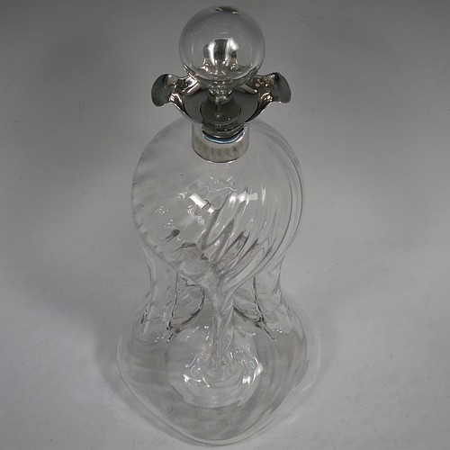 A very pretty Antique Victorian Sterling Silver and cut-crystal glug-glug decanter, having swirl-flute shoulders and clear bottom body, with four pinched and fluted central waists between, a plain round neck mount with four pouring spouts, and a hand-cut spherical crystal stopper. Made by Henry Miller of Birmingham in 1898. The dimensions of this fine hand-made antique silver and crystal glug glug decanter are height 28 cms (11 inches), and width at base 11.5 cms (4.5 inches).   