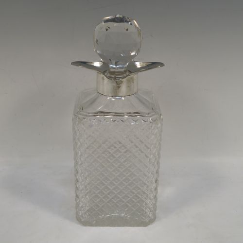 A very handsome Antique Sterling Silver and hand-cut crystal decanter, having a square cross-section body with straight sides and hand-cut hobnail decoration, a plain silver collar with four pouring spouts, and an original hand-cut stopper. Made by the Davies Brothers of Birmingham in 1913. The dimensions of this fine hand-made antique silver and crystal decanter are height 24 cms (9.5 inches), and 9.5 cms (3.75 inches) square.   