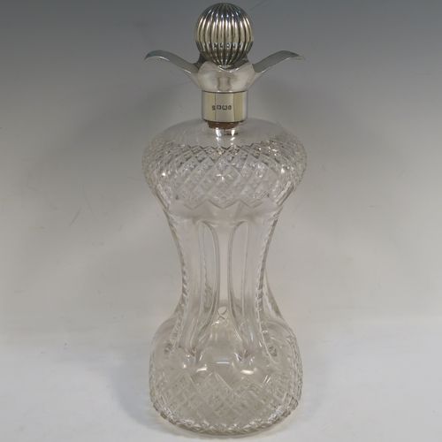 A large and very pretty Antique Victorian Sterling Silver and hand-cut crystal glug-glug decanter, having a hobnail pattern body, with four pinched and fluted central waists between, a plain round neck mount with four spouts, and a silver fluted and cork stopper. This beautiful antique silver and crystal decanter was made by Thomas Russell of Sheffield in 1894. The dimensions of this fine hand-made antique silver and crystal glug glug decanter are height 30 cms (11.75 inches), and width at base 12.5 cms (5 inches). Please note that this item is monogrammed opposite the hallmarks on the silver neck.