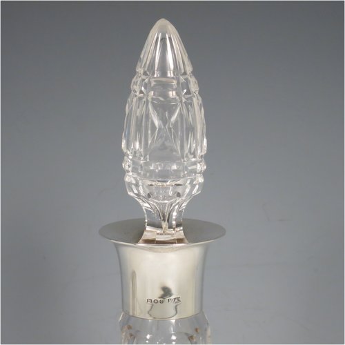 A Sterling Silver and hand-cut crystal pair of decanters, having tear-drop bodies and tapering sides, with hand-cut geometrical decoration, silver collars and lips, and original stoppers. Made by Mappin & Webb of London in 1938. The dimensions of these fine hand-made silver and crystal decanters are height 32 cms (12.5 inches), and diameter 12 cms (4.75 inches).   