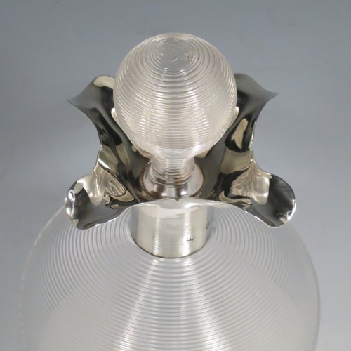 An Antique Victorian large Sterling Silver and cut-crystal glug-glug decanter, having a ribbed body with pinched and fluted central waists, plain round necks with four pouring spouts, and original hand-cut stopper. Made by John N. Mappin of London in 1893. The dimensions of this fine hand-made silver and crystal glug glug decanter are height 29 cms (11.5 inches), and width 13 cms (5 inches).   