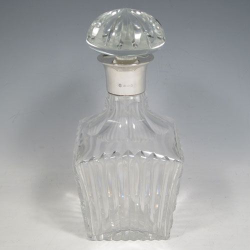 Sterling silver and hand-cut crystal decanter, having a square cross-section body with tapering sides, hand-cut fluted decoration, a silver collar with lip, and original fluted stopper. Made by Barker Brothers Ltd., of Birmingham in 1939. The dimensions of this fine silver and crystal decanter are height 23 cms (9 inches), and width 10 cms (4 inches).