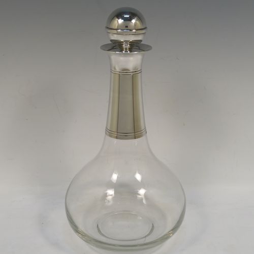 A very elegant Silver Plated and hand-blown glass bodied decanter, having a plain round silver-plated long neck with two bands of hand-chased reeded decoration, an original plain round silver-plated stopper, and a plain round glass body. This handsome silver-plated decanter was made in ca. 1960. The dimensions of this fine hand-made  silver plated and glass decanter are height 26 cms (10.25 inches), and 13.5 cms (5.25 inches) in diameter at its widest point.   