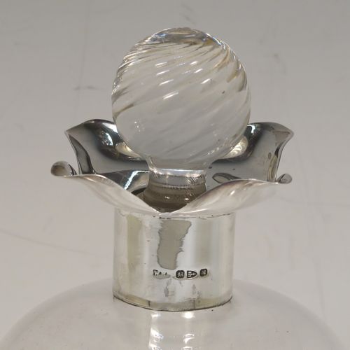 A very pretty Antique Victorian Sterling Silver and hand-cut crystal glug-glug decanter, having a plain body with four pinched and fluted central waists between, a plain round neck mount with four spouts, and a swirl fluted crystal stopper. This beautiful antique silver and crystal decanter was made by William Hammon of Chester in 1895. The dimensions of this fine hand-made antique silver and crystal glug glug decanter are height 21.5 cms (8.5 inches), and width at base 9 cms (3.5 inches).