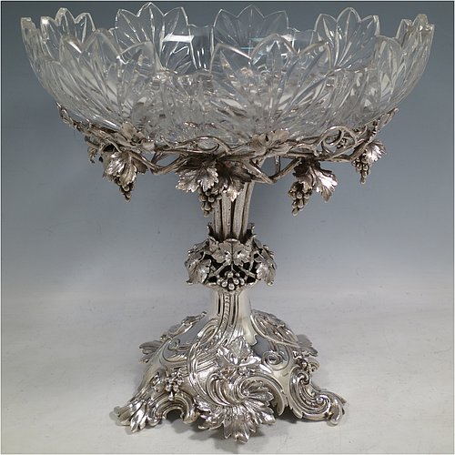 A very pretty Antique Victorian Sterling Silver compote or dessert stand with applied cast grape vine work, and sitting on a pedestal foot with hand-chased anthemion leaves, together with a hand-cut crystal bowl. Made by the Barnard Brothers of London in 1856. The dimensions of this fine hand-made antique silver and crystal dessert or compote stand are height 28 cms (11 inches), diameter of bowl 25.5 cms (10 inches), and it weighs approx. 1,273g (41 troy ounces).   