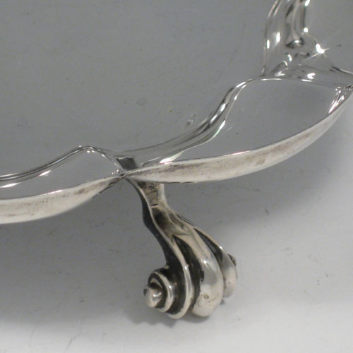 Sterling silver dish, having a clover-leaf style body, with shaped and lobed border, and sitting on four cast scroll feet. Made by Thomas Bradbury & Sons of Sheffield in 1923. The dimensions of this fine silver dish are diameter 23 cms (9 inches), height 5.5 cms (2.75 inches), and it weighs approx. 654g (21.1 troy ounces).