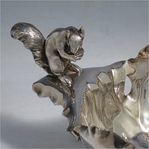 An Antique Victorian Silver Plated very unusual squirrel nut dish, having an oval body all hand-chased and made to look like half a walnut, with a cast squirrel handle, and sitting on four cast foliate feet. Made by the Pairpoint Brothers  of Sheffield in ca. 1880. The dimensions of this fine hand-made antique silver-plated bread dish are length 28 cms (11 inches), width 19 cms (7.5 inches), and height 13 cms (5 inches).    