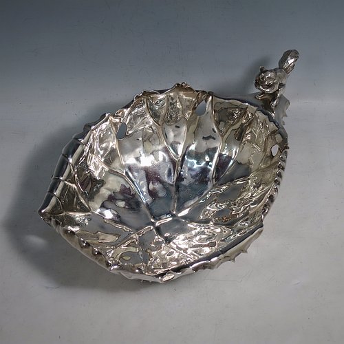 An Antique Victorian Silver Plated very unusual squirrel nut dish, having an oval body all hand-chased and made to look like half a walnut, with a cast squirrel handle, and sitting on four cast foliate feet. Made by the Pairpoint Brothers  of Sheffield in ca. 1880. The dimensions of this fine hand-made antique silver-plated bread dish are length 28 cms (11 inches), width 19 cms (7.5 inches), and height 13 cms (5 inches).    