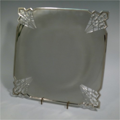 A Sterling Silver Art Deco very elegant style serving dish, having a square-shaped slightly concave body, with hand-pierced geometrical corners, and sitting on a pedestal foot. Made by Mappin and Webb of Sheffield in 1935. The dimensions of this fine hand-made sterling silver Art Deco dish are 23 cms (9 inches) square, height 2.5 cms (1 inch), and it weighs approx. 430g (13.9 troy ounces).   