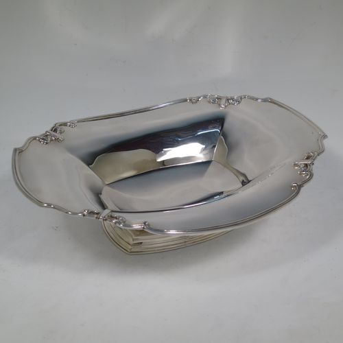 A handsome Sterling Silver Art Deco serving dish, having a panelled body, with an applied reed and scroll border, and sitting on a stepped pedestal foot. Made by Manoah Rhodes and Sons Ltd., of London in 1923. The dimensions of this fine hand-made silver Art Deco dish are length 26 cms (10.25 inches), width 20 cms (8 inches), height 7 cms (2.75 inches), and it weighs approx. 470g (15 troy ounces).   