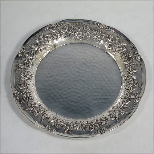 A very pretty Scottish Sterling Silver Arts and Crafts style table dish, having a round hand-hammered body, with an applied scroll border and hand-chased floral wild rose and thorn-leaf decoration. Made by Edward and Sons of Glasgow in 1922. The dimensions of this fine hand-made Arts and Crafts silver dish are diameter 18 cms (7 inches), and it weighs approx. 203g (6.5 troy ounces).    