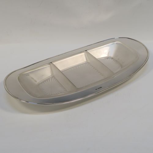 A very elegant Sterling silver hors doeuvres dish in an Art Deco style, having a very plain rectangular body with rounded ends, and three removable star hand-cut frosted glass liners. This beautiful and stylish dish was made by Emile Viner of Sheffield 1937. The dimensions of this fine hand-made silver serving dish are length 33 cms (13 inches), width 16.5 cms (6.5 inches), and it weighs approx. 410g (13.2 troy ounces).